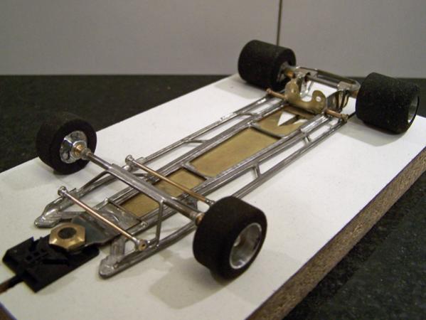 A301
Ret-ro rules in-line open-wheel chassis, using two construction methods (initial hybrid-build technique chassis); all-wire outer frames and separate torsional motor-center-guide section built using 0.010 brass sheet backed with 0.047 wire.