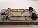 1210-A 
Next chassis design in the 1205/1208&1209 progression; all-wire frame with torsional wire side pans, and two suspended brass pans adjacent...