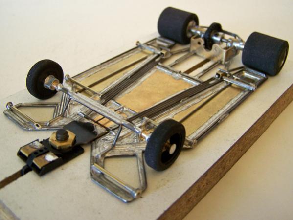 1305-C
Ret-ro rules in-line, adaptation of 1219 framing pattern using the sectional movement of the 1218; all wire frame, with 0.010 brass sheet backed with 0.039 wire inner side pans and wire outer torsional side pans, and a separate center-guide section with torsional inner sections (wire version of H cut) made of 0.010 brass sheet backed with 0.039 wire.
Winner - IRRA GT Coupe, GRRR, ASR Indoormotorsports (King), 4/25/10
Winner - IRRA GT Coupe, GRRR, John's Slot Car Garage (Hillclimb), 8/29/10
Winner - IRRA GT Coupe, GRRR, John's Slot Car Garage (Hillclimb), 1/9/11