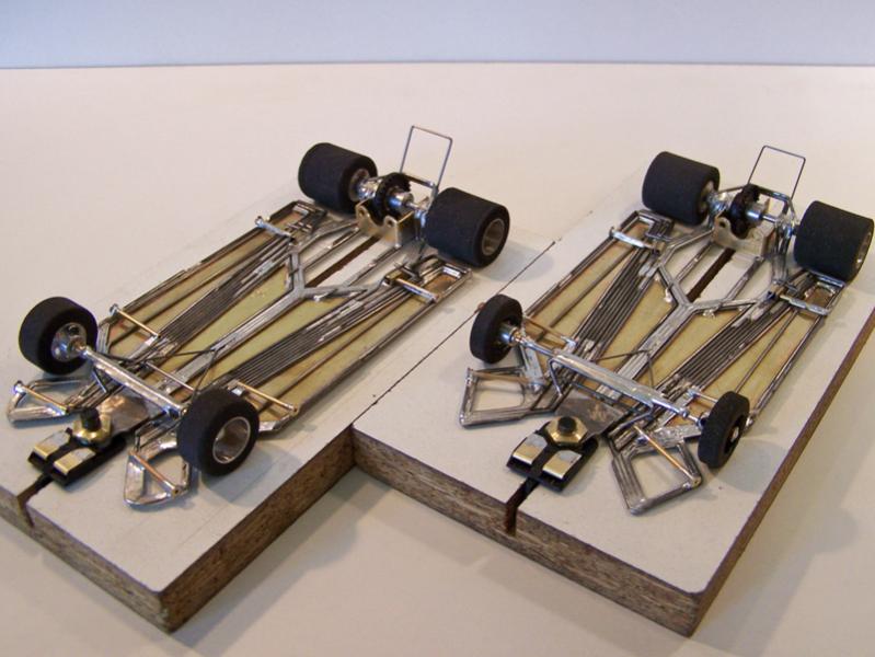 1310-D (left)  &  1310f-Ca (right)

1310-D: 4.5" wheelbase Ret-Ro Stocker modification of 1310-Ca design (designed to fit Outisight OS-601 '68 Dodge Charger body).

1310f-Ca: 3.0" wide modification of 1310-Ca design designed to fit TrueScale TSR-11 Ferarri 330 P4 body (and meet Ret-Ro GT Coupe class).

Both chassis using two construction methods (hybrid-build technique); all-wire frame with damper main rails; separate torsional center-guide section attached to motor box built to be as narrow as possible using only four side-by-side pieces of 0.047 wire, with torsional flanking pans made of 0.010 brass sheet backed with 0.039 wire (wire version of double-V cut); separate left-right torsional rails attached to motor box for front axle uprights; torsional 0.010 brass sheet backed with 0.039 wire inner side pans and perimeter wire outer side pans; angled motor bracket.

Both chassis subsequently refitted with variable spring-wire tension system between center-guide section / front-axle uprights for "chassis tuning".